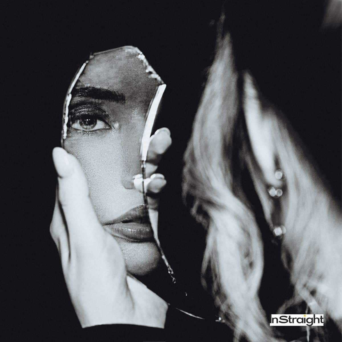 lady looking at the broken mirror (Broken Mirror Superstition)